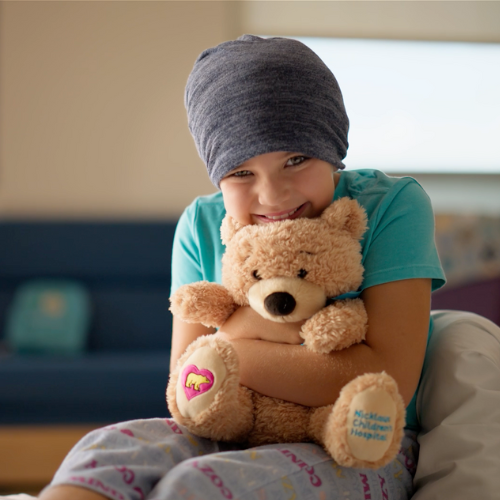 Smiling young girl in a hospital setting representing pediatric care